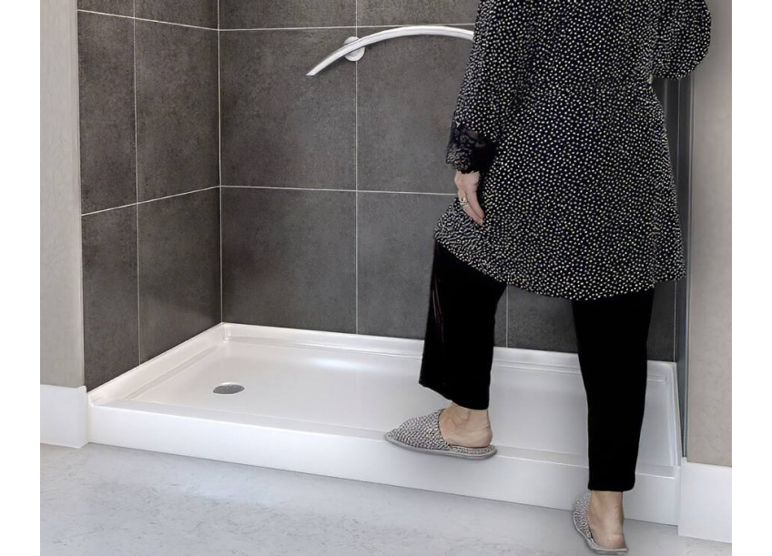 Elderly woman stepping into a walk in Shower Pan from Freedom Showers